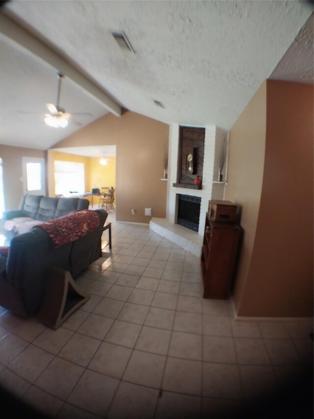 2450 Edgedale Dr, Missouri City, TX 77489 - tiled living area featuring a ceiling fan, a textured ceiling, and a fireplace