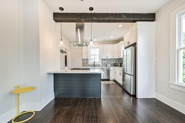 1715 30th St, Galveston, TX 77550 - kitchen with appliances with stainless steel finishes, island range hood, beam ceiling, a sink, and a peninsula