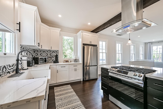 1715 30th St, Galveston, TX 77550 - kitchen with appliances with stainless steel finishes, island exhaust hood, dark wood-style floors, white cabinetry, and recessed lighting