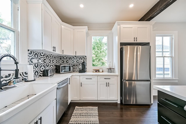 1715 30th St, Galveston, TX 77550 - kitchen with appliances with stainless steel finishes, a sink, tasteful backsplash, white cabinets, and recessed lighting