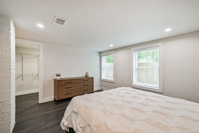 1715 30th St, Galveston, TX 77550 - bedroom featuring dark wood-style flooring, baseboards, a spacious closet, recessed lighting, and a closet