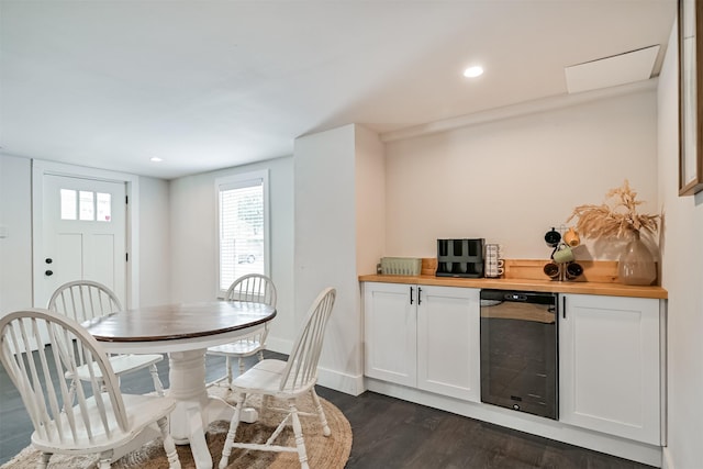 1715 30th St, Galveston, TX 77550 - dining area featuring wine cooler, dark wood-style flooring, baseboards, recessed lighting, and a dry bar