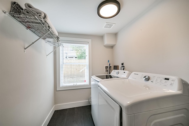 1715 30th St, Galveston, TX 77550 - laundry area featuring washing machine and clothes dryer, baseboards, and dark wood-style flooring