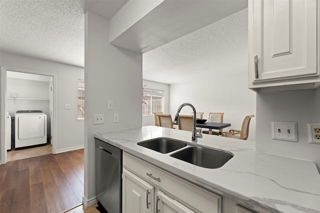8101 Amelia Rd Unit 106, Houston, TX 77055 - kitchen with dishwasher, separate washer and dryer, a sink, a textured ceiling, and dark wood finished floors