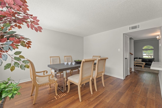 8101 Amelia Rd Unit 106, Houston, TX 77055 - dining room with wood finished floors, a textured ceiling, and baseboards