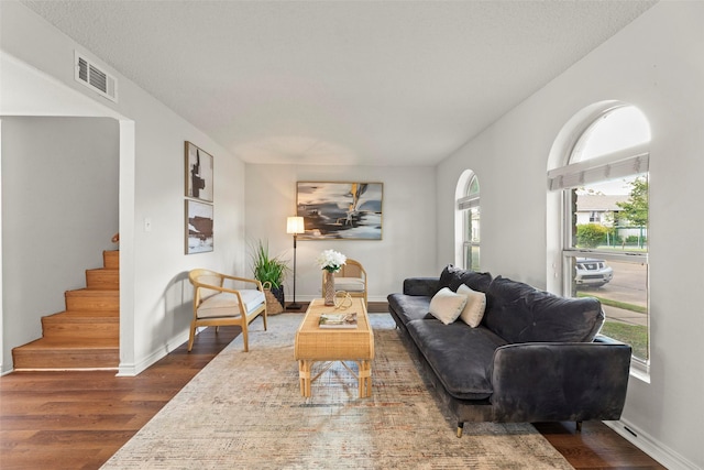 8101 Amelia Rd Unit 106, Houston, TX 77055 - living area with dark wood-style floors, stairway, and baseboards