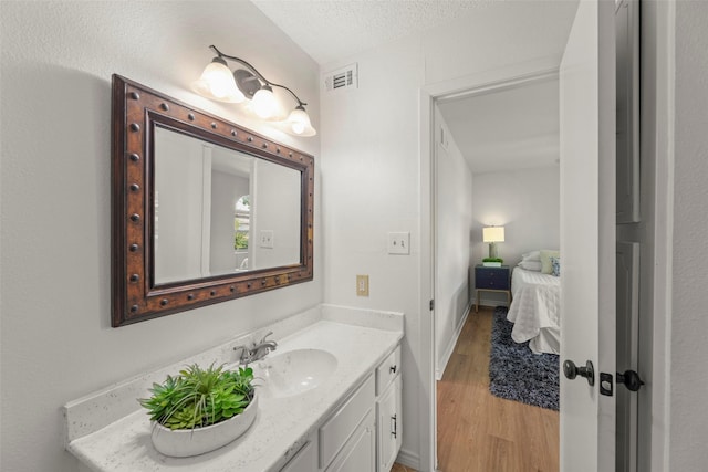 8101 Amelia Rd Unit 106, Houston, TX 77055 - ensuite bathroom featuring vanity and wood finished floors