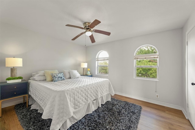 8101 Amelia Rd Unit 106, Houston, TX 77055 - bedroom with wood finished floors, baseboards, and a ceiling fan