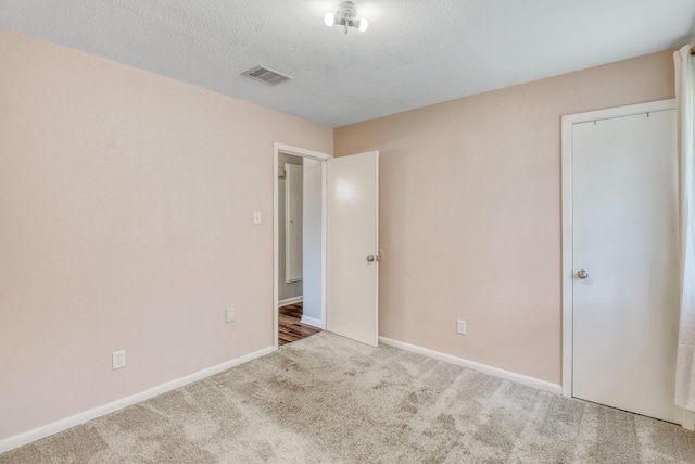 1323 W Donovan St, Houston, TX 77091 - unfurnished bedroom featuring carpet flooring and a textured ceiling