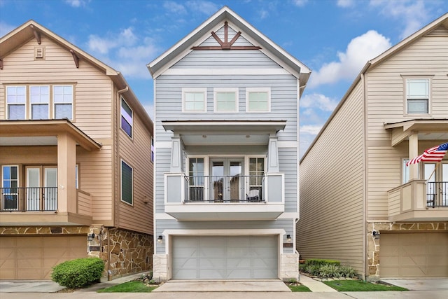 6013 Kansas St Unit B, Houston, TX 77007 - view of front of home with an attached garage, a balcony, and stone siding