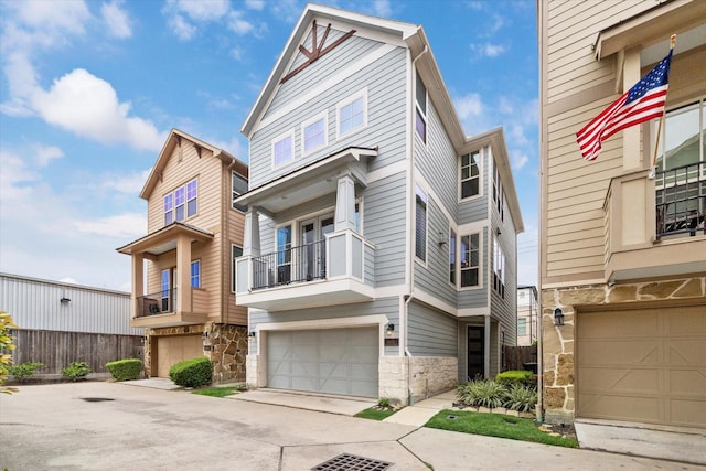 6013 Kansas St Unit B, Houston, TX 77007 - multi unit property with stone siding, an attached garage, driveway, and a balcony
