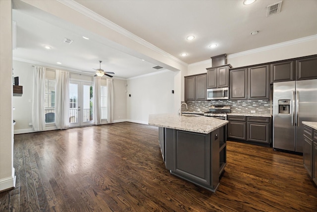 6013 Kansas St Unit B, Houston, TX 77007 - kitchen featuring stainless steel appliances, a sink, decorative backsplash, baseboards, and crown molding