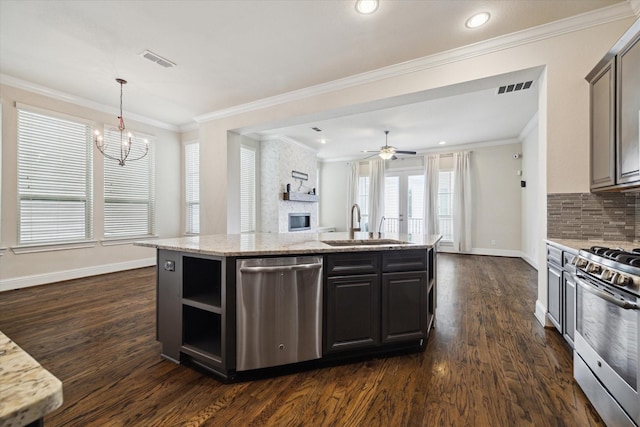 6013 Kansas St Unit B, Houston, TX 77007 - kitchen with appliances with stainless steel finishes, dark wood-style flooring, a sink, a chandelier, and a kitchen island with sink
