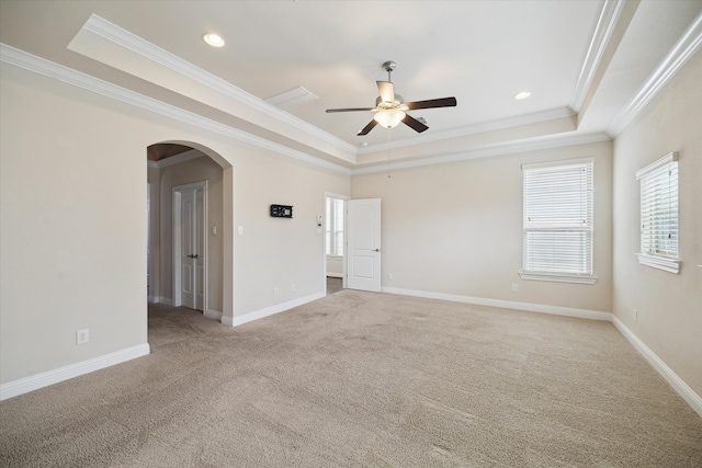 6013 Kansas St Unit B, Houston, TX 77007 - empty room with a raised ceiling, ornamental molding, arched walkways, a ceiling fan, and light colored carpet