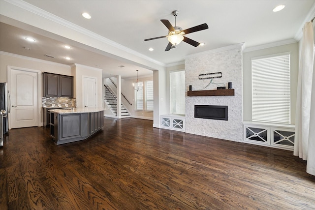 6013 Kansas St Unit B, Houston, TX 77007 - unfurnished living room featuring dark wood-style flooring, stairs, ceiling fan, recessed lighting, and a stone fireplace