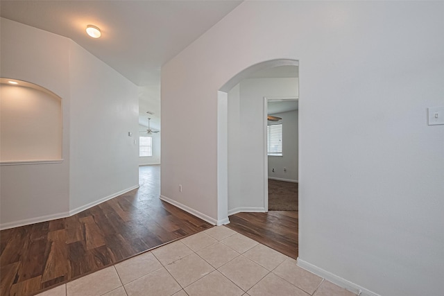 19826 Imperial Stone Dr, Houston, TX 77073 - hallway with arched walkways, wood finished floors, and baseboards