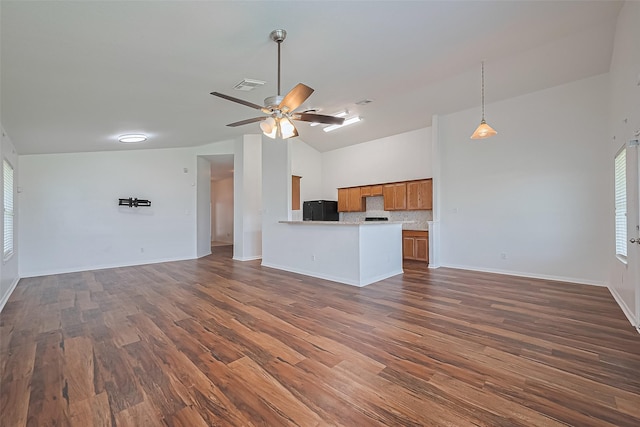 19826 Imperial Stone Dr, Houston, TX 77073 - unfurnished living room featuring dark wood-style floors, ceiling fan, plenty of natural light, baseboards, and high vaulted ceiling