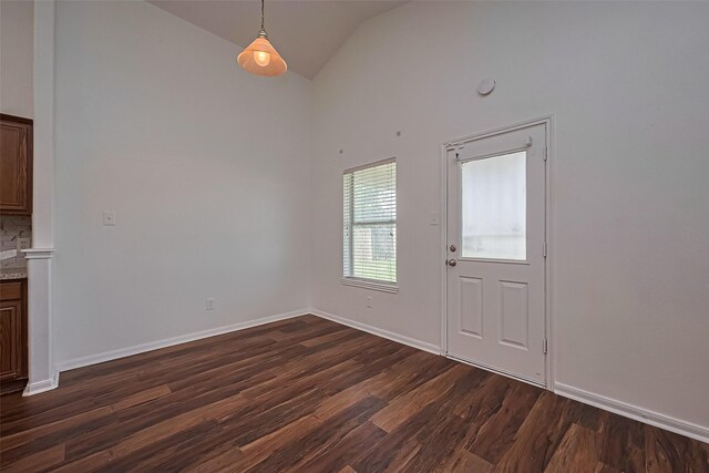19826 Imperial Stone Dr, Houston, TX 77073 - unfurnished dining area with dark wood-type flooring, baseboards, and high vaulted ceiling