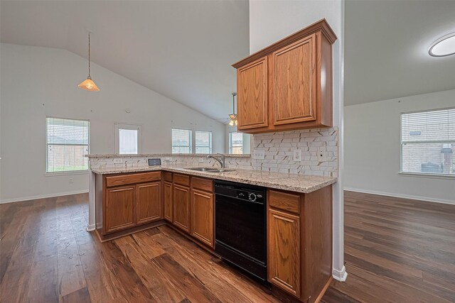 19826 Imperial Stone Dr, Houston, TX 77073 - kitchen with black dishwasher, a sink, lofted ceiling, brown cabinetry, and a peninsula