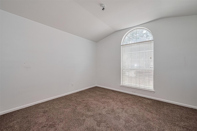 19826 Imperial Stone Dr, Houston, TX 77073 - unfurnished room featuring vaulted ceiling, dark colored carpet, and baseboards