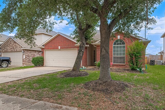 19826 Imperial Stone Dr, Houston, TX 77073 - traditional-style home with brick siding, an attached garage, central AC, and driveway