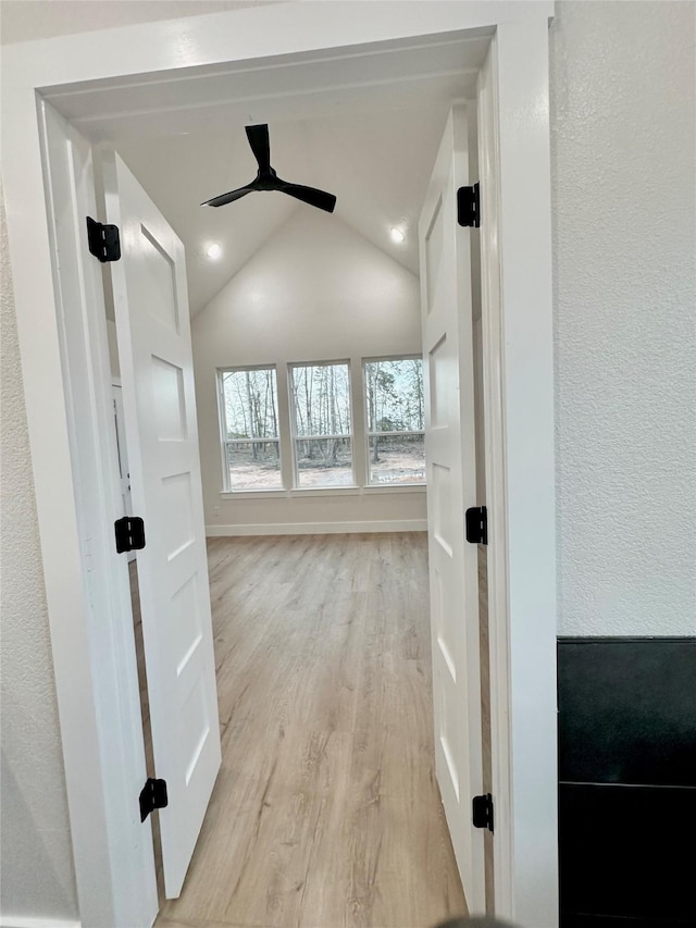 1031 Denson Allen Rd, Coldspring, TX 77331 - hallway with light wood-style flooring, vaulted ceiling, recessed lighting, and a textured wall