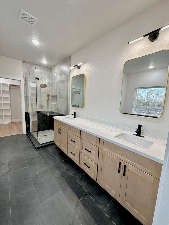 1031 Denson Allen Rd, Coldspring, TX 77331 - full bathroom with double vanity, a stall shower, and tile patterned flooring