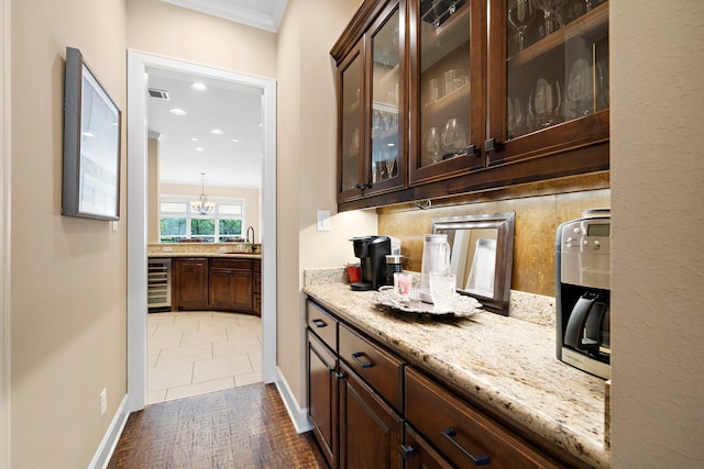 5003 Woodside Ln, Fulshear, TX 77441 - bar area featuring ornamental molding, wine cooler, a chandelier, wood finished floors, and recessed lighting