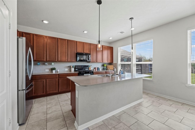 1435 Wheatley Hill Ln, Katy, TX 77494 - kitchen with black appliances, a sink, light countertops, decorative light fixtures, and an island with sink