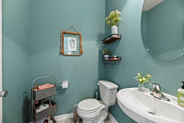 1435 Wheatley Hill Ln, Katy, TX 77494 - half bath featuring a sink, toilet, and baseboards