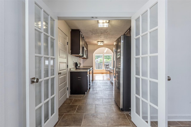719 Shaver St, Pasadena, TX 77506 - kitchen featuring stainless steel appliances, french doors, arched walkways, and light countertops