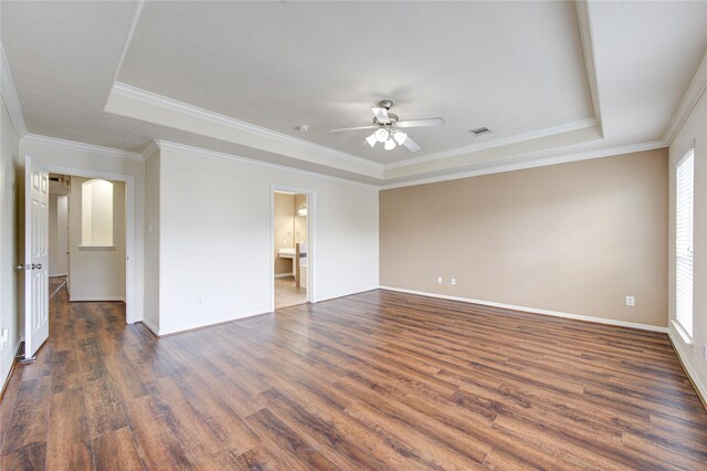 14410 Basalt Ln, Houston, TX 77077 - spare room featuring a tray ceiling, dark wood-style flooring, ceiling fan, baseboards, and ornamental molding