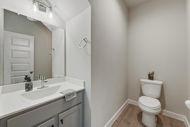 2231 Bright Sunrise Trl, Fresno, TX 77545 - half bath with toilet, vanity, baseboards, and wood finished floors