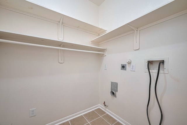 14723 Belterraza Dr, Houston, TX 77083 - washroom featuring hookup for a gas dryer, washer hookup, electric dryer hookup, baseboards, and tile patterned floors
