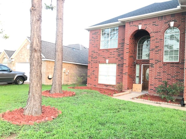 14723 Belterraza Dr, Houston, TX 77083 - view of front of house featuring brick siding, a front lawn, and a shingled roof