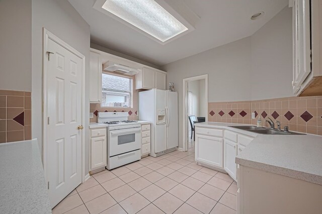 14723 Belterraza Dr, Houston, TX 77083 - kitchen featuring white appliances, a sink, light countertops, and white cabinetry