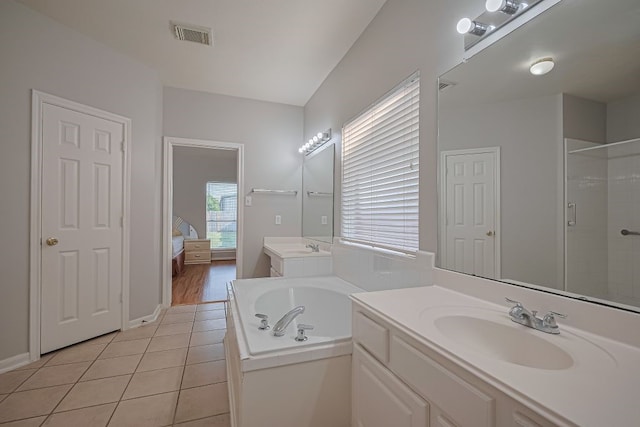 14723 Belterraza Dr, Houston, TX 77083 - ensuite bathroom featuring a bath, two vanities, tiled shower, tile patterned flooring, and baseboards
