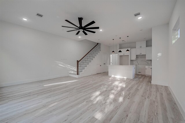 7002 Sidney St, Houston, TX 77021 - unfurnished living room with stairway, light wood-type flooring, baseboards, recessed lighting, and a ceiling fan
