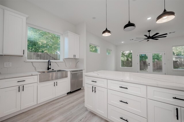 7002 Sidney St, Houston, TX 77021 - kitchen featuring dishwasher, a sink, decorative backsplash, a ceiling fan, and pendant lighting