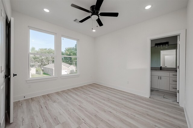 7002 Sidney St, Houston, TX 77021 - unfurnished bedroom with a sink, recessed lighting, light wood-type flooring, baseboards, and ensuite bathroom