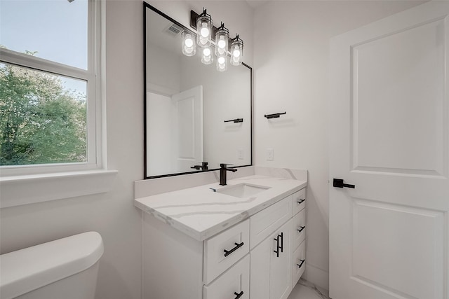 7002 Sidney St, Houston, TX 77021 - bathroom featuring healthy amount of natural light, vanity, and toilet