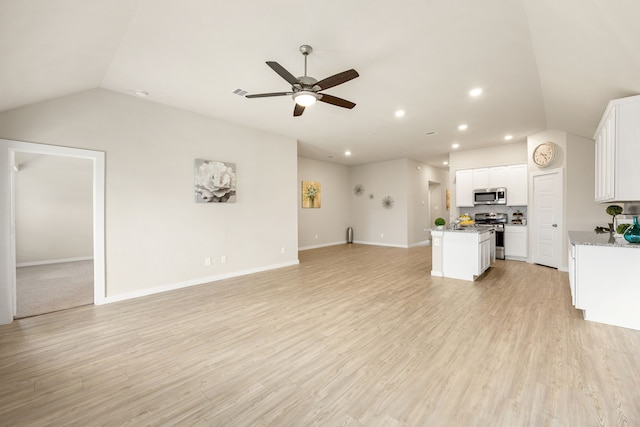 723 Larkspur Shadow Dr, Magnolia, TX 77354 - unfurnished living room featuring vaulted ceiling, ceiling fan, recessed lighting, light wood-style flooring, and baseboards