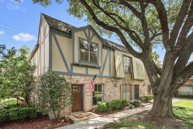 14703 Barryknoll Ln Unit 26, Houston, TX 77079 - tudor-style house with a shingled roof, stucco siding, and brick siding
