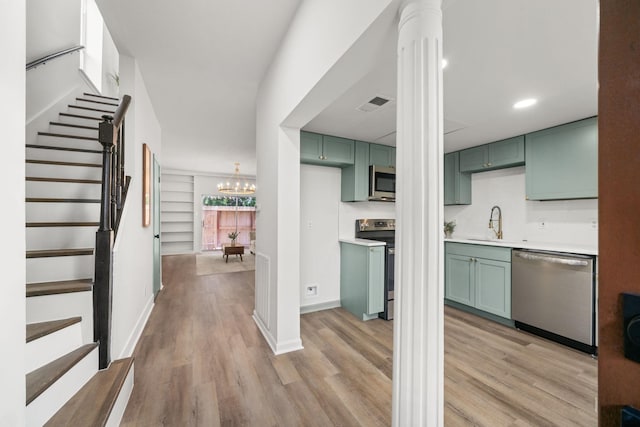 14703 Barryknoll Ln Unit 26, Houston, TX 77079 - foyer with light wood-style flooring, stairway, a chandelier, decorative columns, and recessed lighting