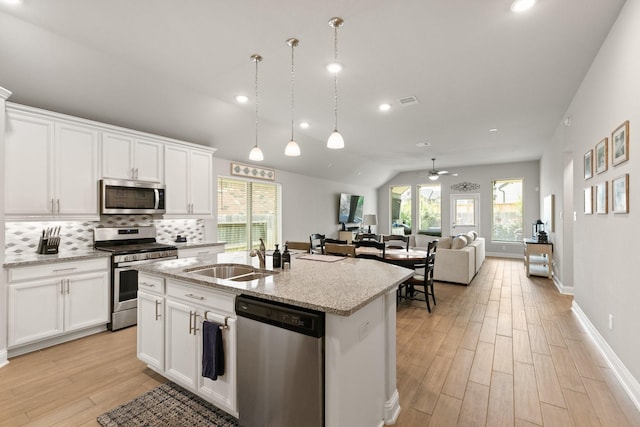 18226 Sofia Willow Way, Cypress, TX 77429 - kitchen with stainless steel appliances, light wood-style floors, backsplash, healthy amount of natural light, and recessed lighting