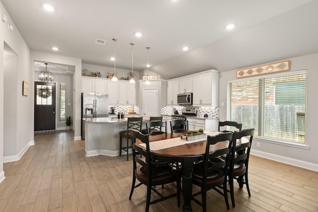 18226 Sofia Willow Way, Cypress, TX 77429 - dining area featuring plenty of natural light, light wood finished floors, vaulted ceiling, a chandelier, and recessed lighting