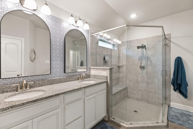 18226 Sofia Willow Way, Cypress, TX 77429 - bathroom featuring a stall shower, double vanity, and lofted ceiling