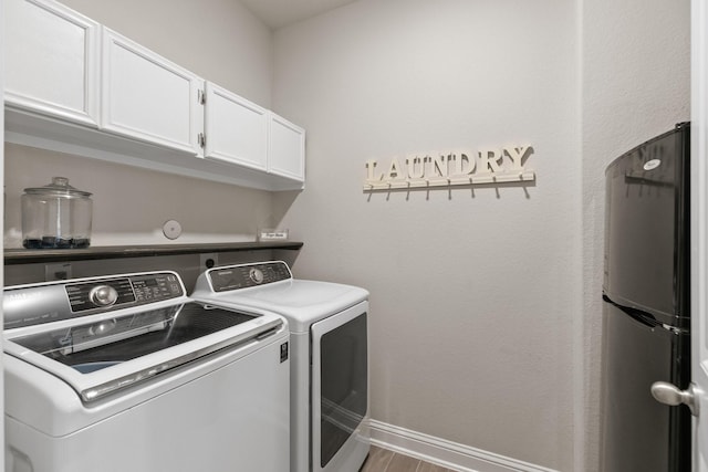 18226 Sofia Willow Way, Cypress, TX 77429 - washroom with cabinet space, washer and clothes dryer, and wood finished floors