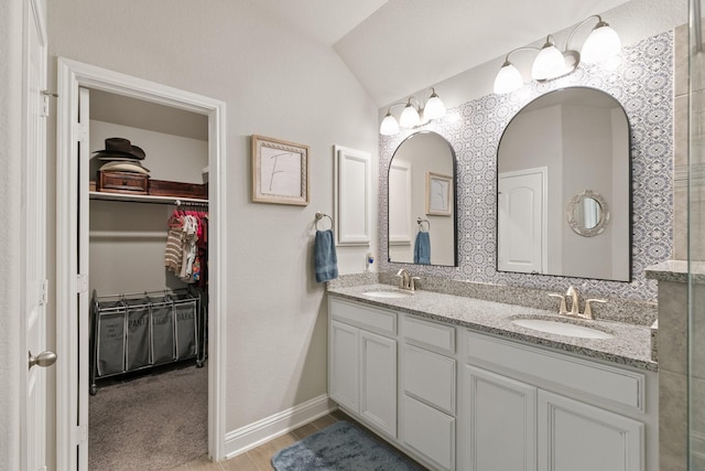 18226 Sofia Willow Way, Cypress, TX 77429 - full bathroom featuring double vanity, a walk in closet, and lofted ceiling