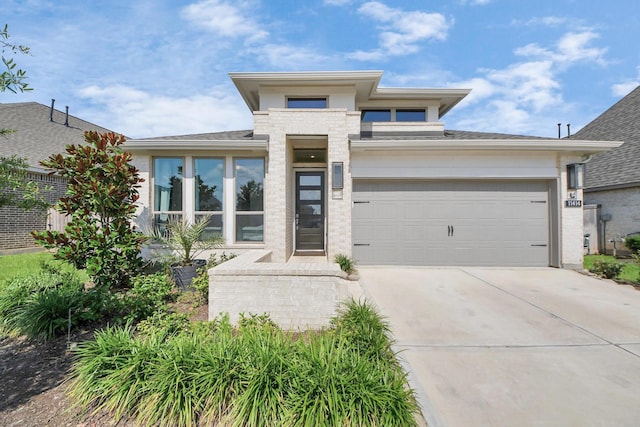 11414 Bush Clover Dr, Cypress, TX 77433 - view of front of property with driveway, a garage, brick siding, and roof with shingles